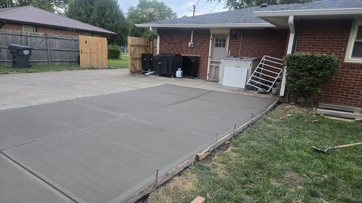 Fresh concrete driveway widening with broom finish and control joints, Anderson Indiana