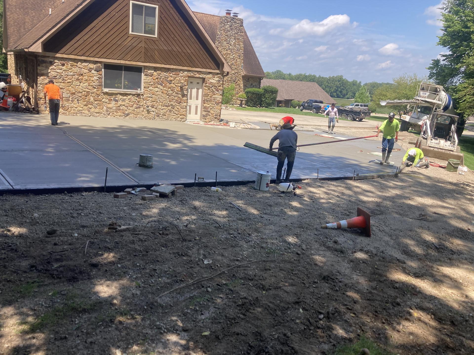 Residential driveway pour with crew screeding, Anderson Indiana