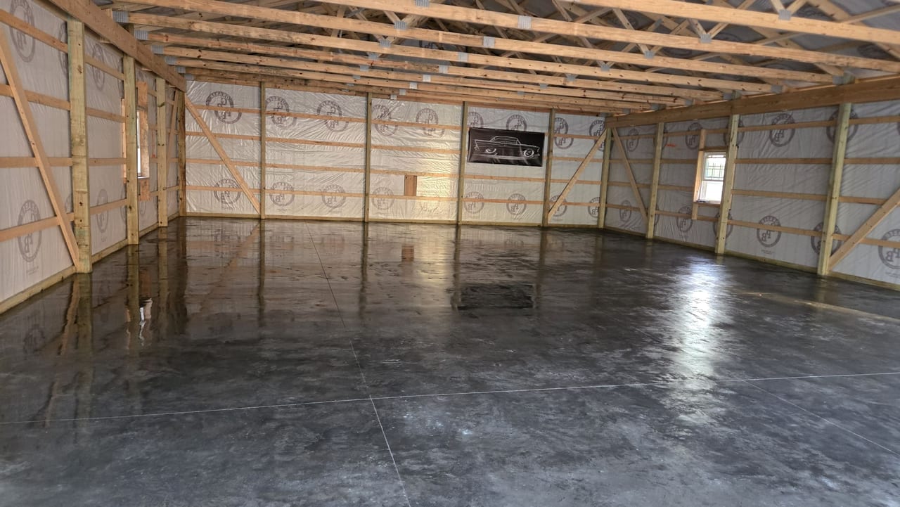 Large-scale pole barn concrete floor with power float finish showing control joint grid, Madison County Indiana