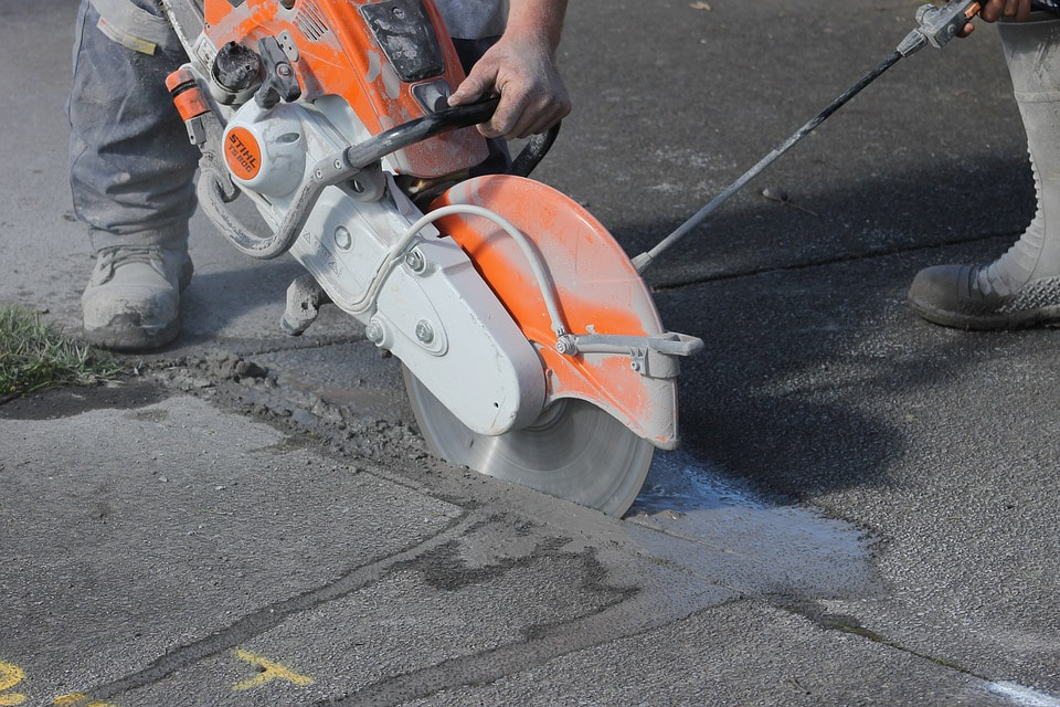 Concrete saw actively sawing 